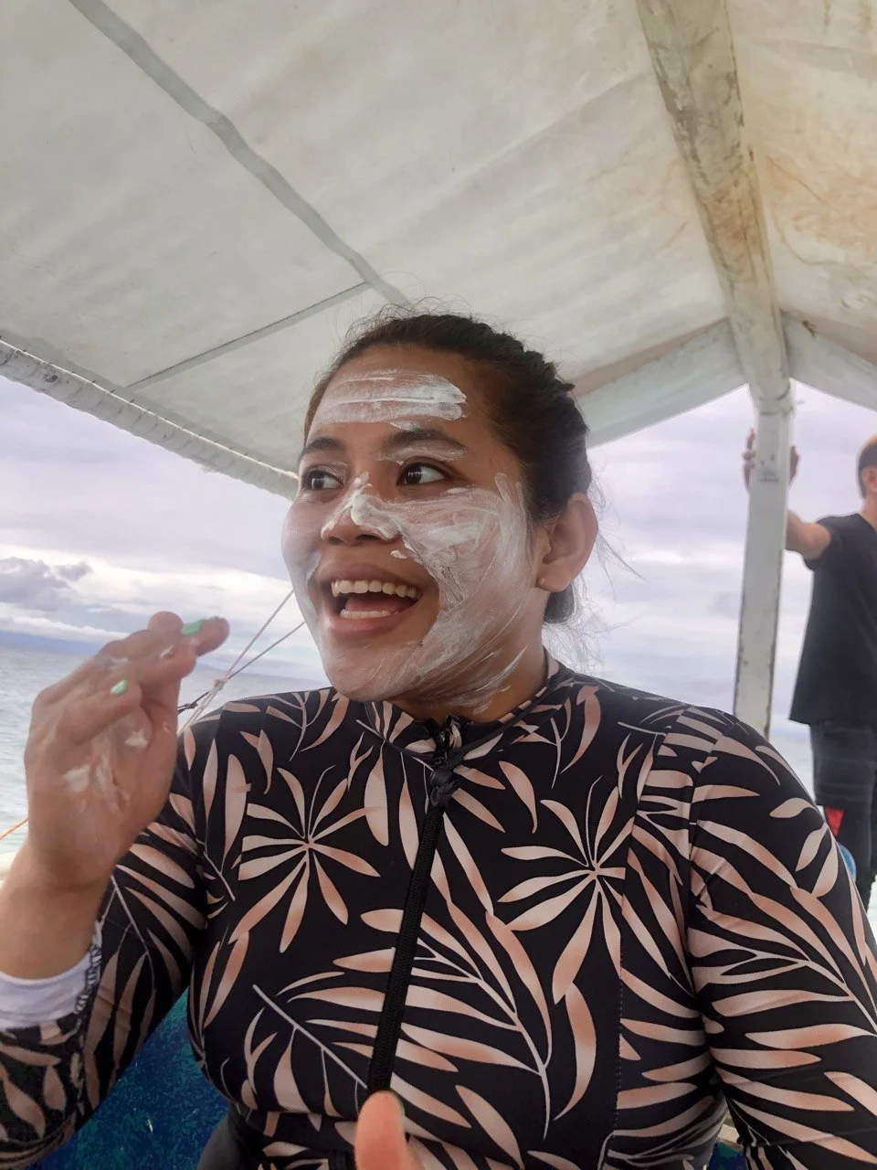 Judith, a real human on the MajorMajor team, smiling on a boat in the Philippines